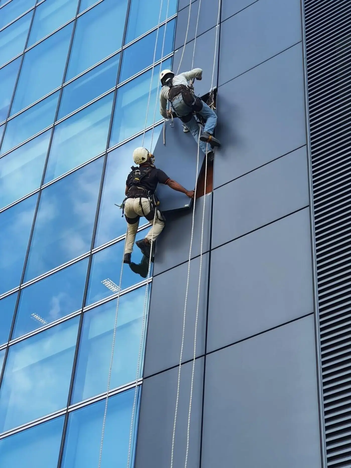 Rope access team on a high-rise building reviewing safety set-up in Singapore